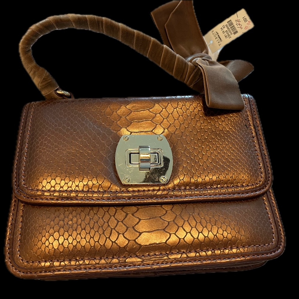 Bronze leather purse with velvet-wrapped handle and bow.